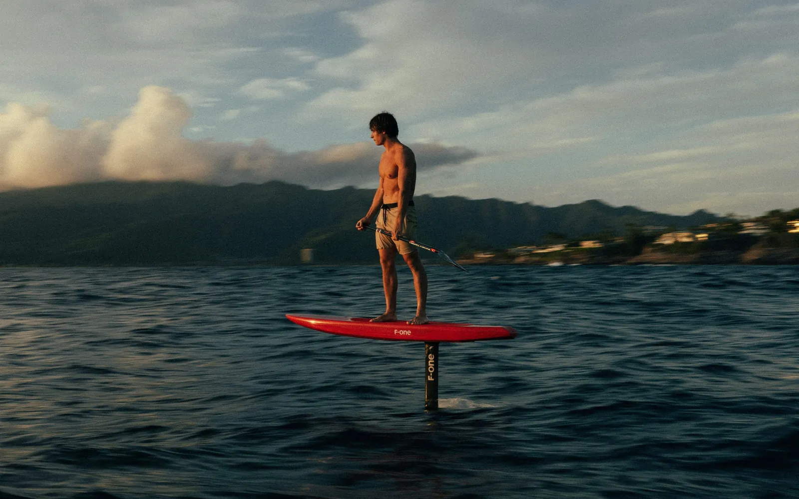 Edo Tanas flying a foil on a downwind run with the Koolau range behind