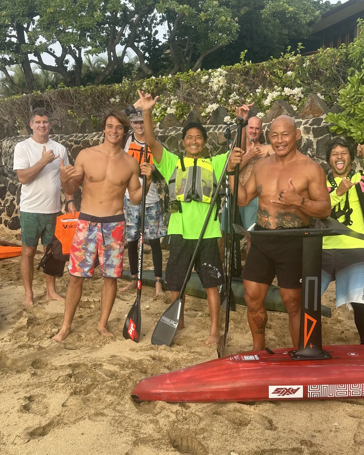 Edo Tanas with a group of foilers and their boards on an Oahu beach