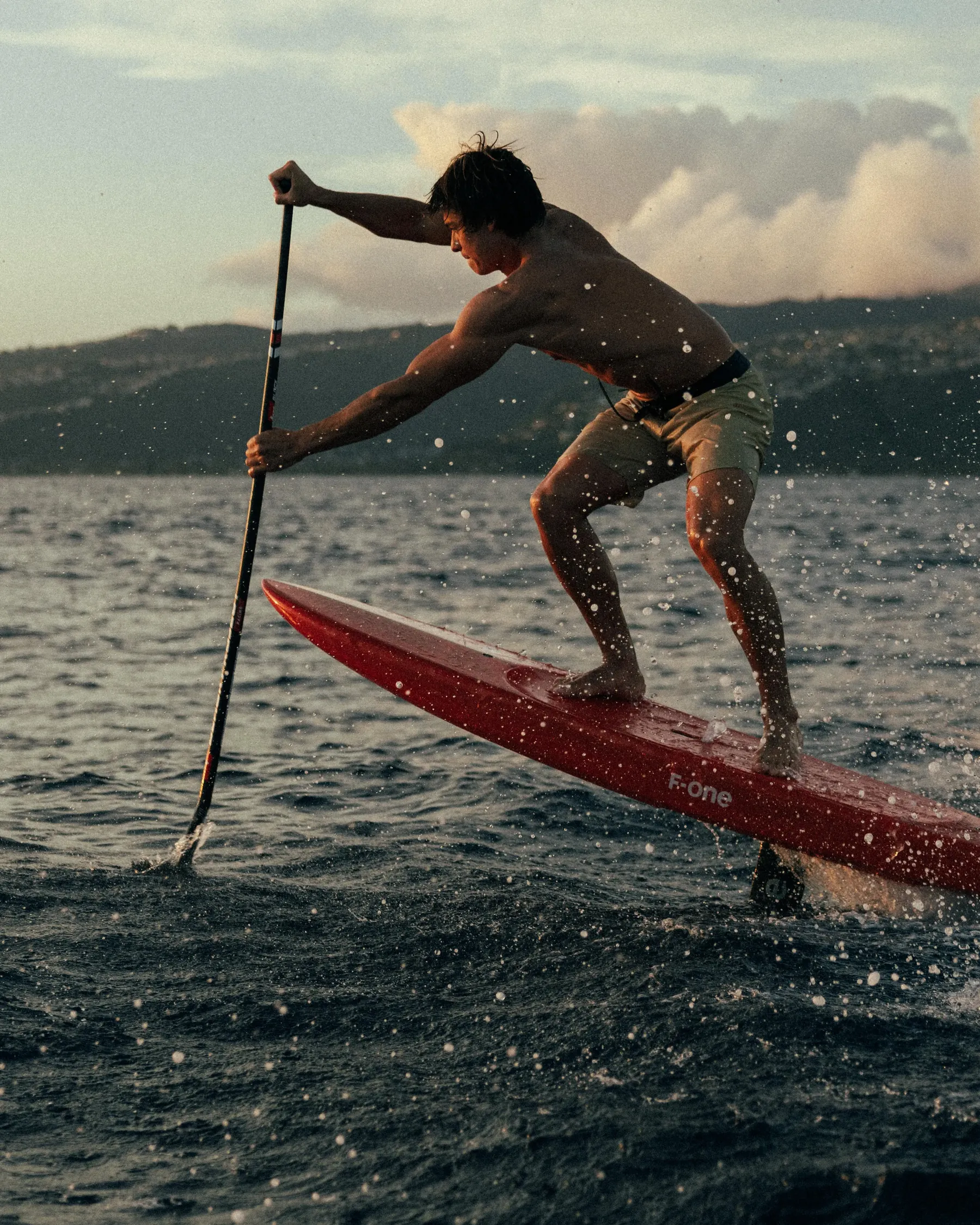 Edo Tanas driving a SUP foil through open-ocean chop off Oahu