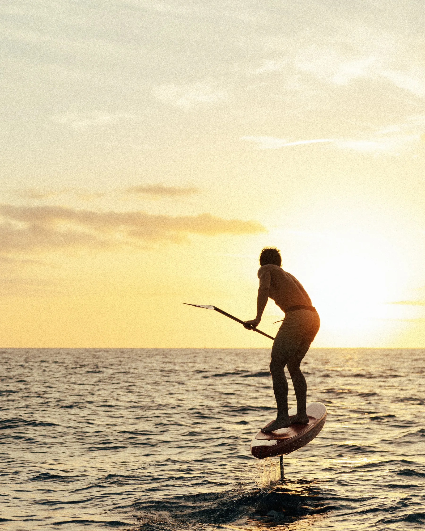 Edo Tanas foiling into the sunset off Oahu