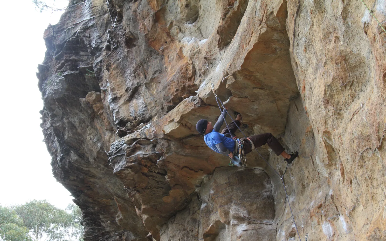 Climber on an overhanging sandstone wall in the Blue Mountains